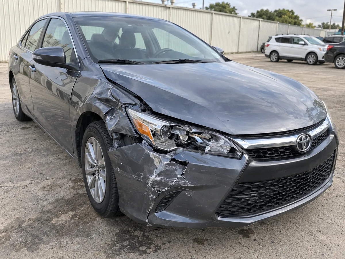 Before: grey sedan with damage around the front bumper, fender and headlight.